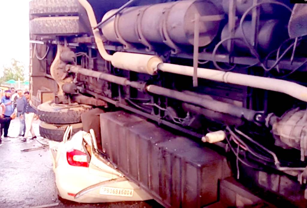 Bus overturns over car after crossing divider 26 passengers injured